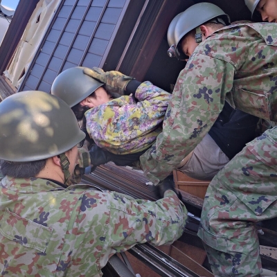 Troops from the 10th Division rescue a victim trapped under a collapsed house
