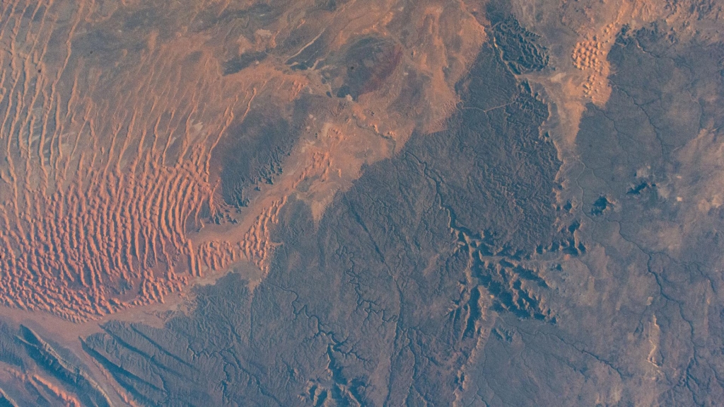 (Jan. 3, 2024) --- Sand dunes, sandstone plateaus, and rocky platforms that comprise the Tassili N'Ajjer National Park in the southeastern portion of Algeria are pictured from the International Space Station as it orbited 261 mile above the Sahara.